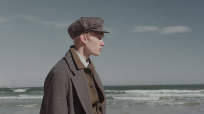 Video of man exploring a coastal landscape wearing a selection of different shoes, boots, loafers, and trainers.