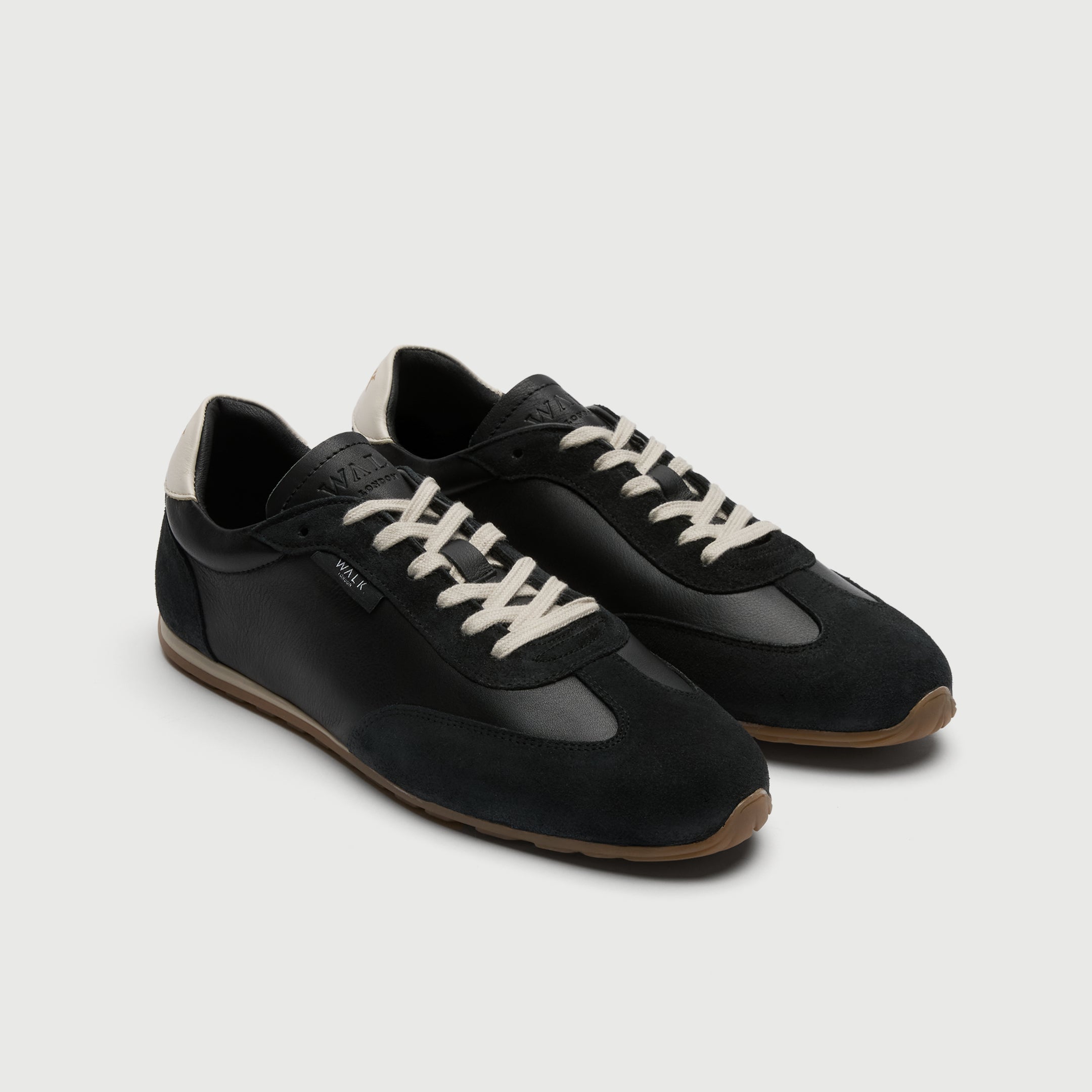 Video of man wearing Walk London Bologna Trainers in Black Leather and Suede with wide green trousers