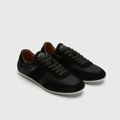 Video of man wearing Walk London Firenze Trainers in black suede and textile with green trousers