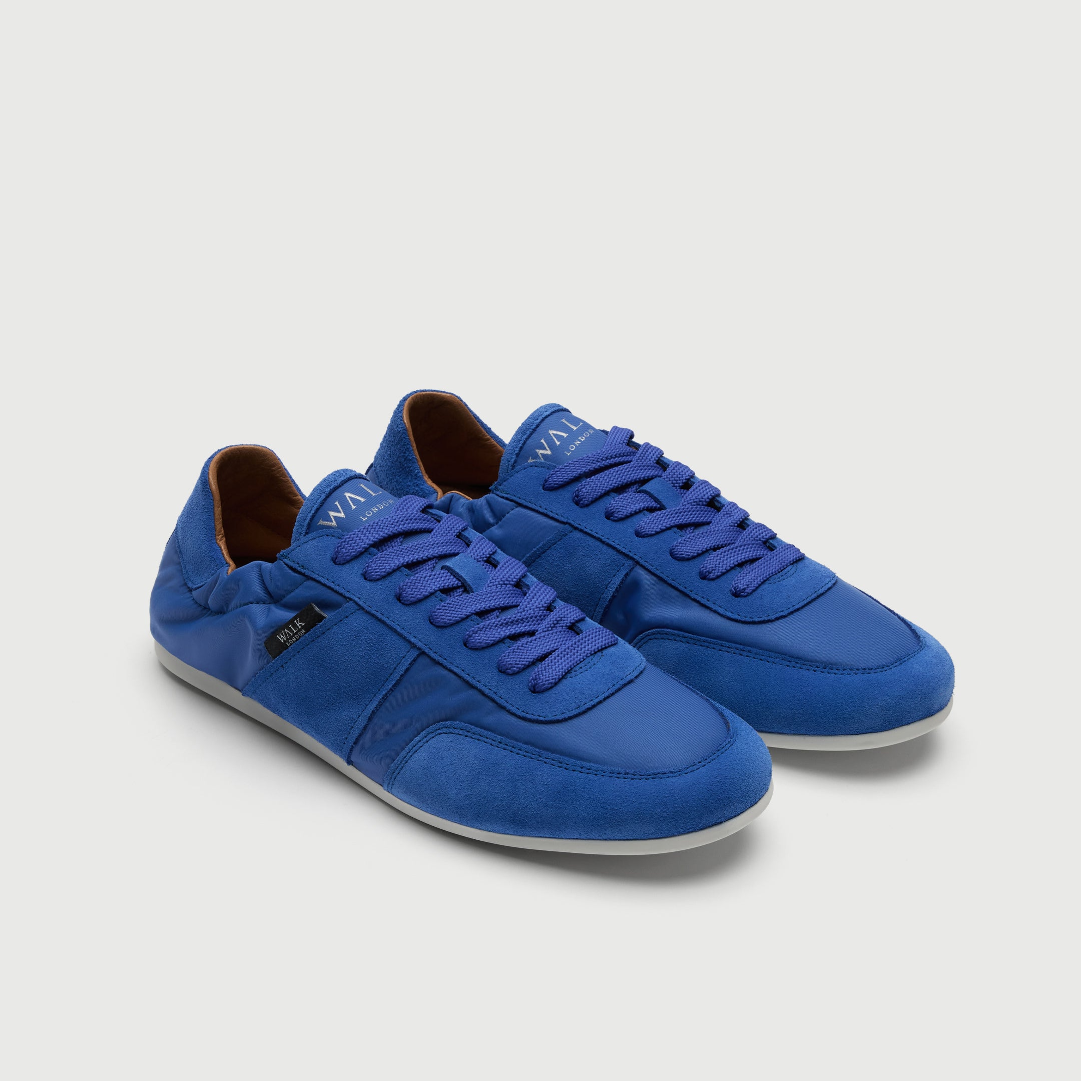 Video of man wearing Walk London Firenze Trainers in blue suede and textile with black trousers