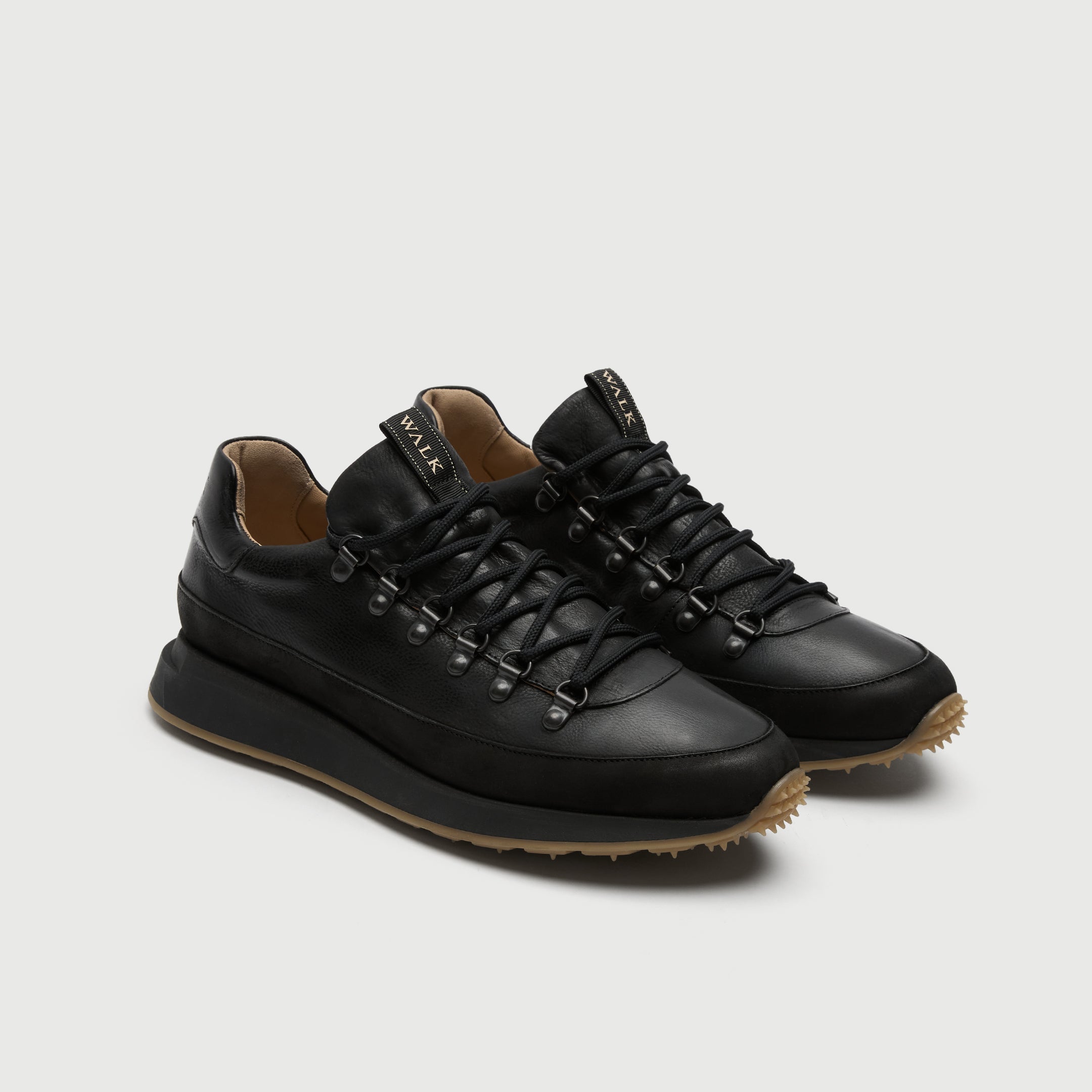 Black leather pair of walk london hampsetad hiking sneaker on a light grey background
