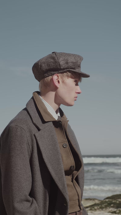 Video of man exploring a coastal landscape wearing a selection of different shoes, boots, loafers, and trainers.
