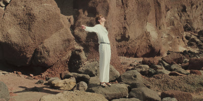 Video of man in summer outfits in a coastal landscape wearing loafers and sandals 