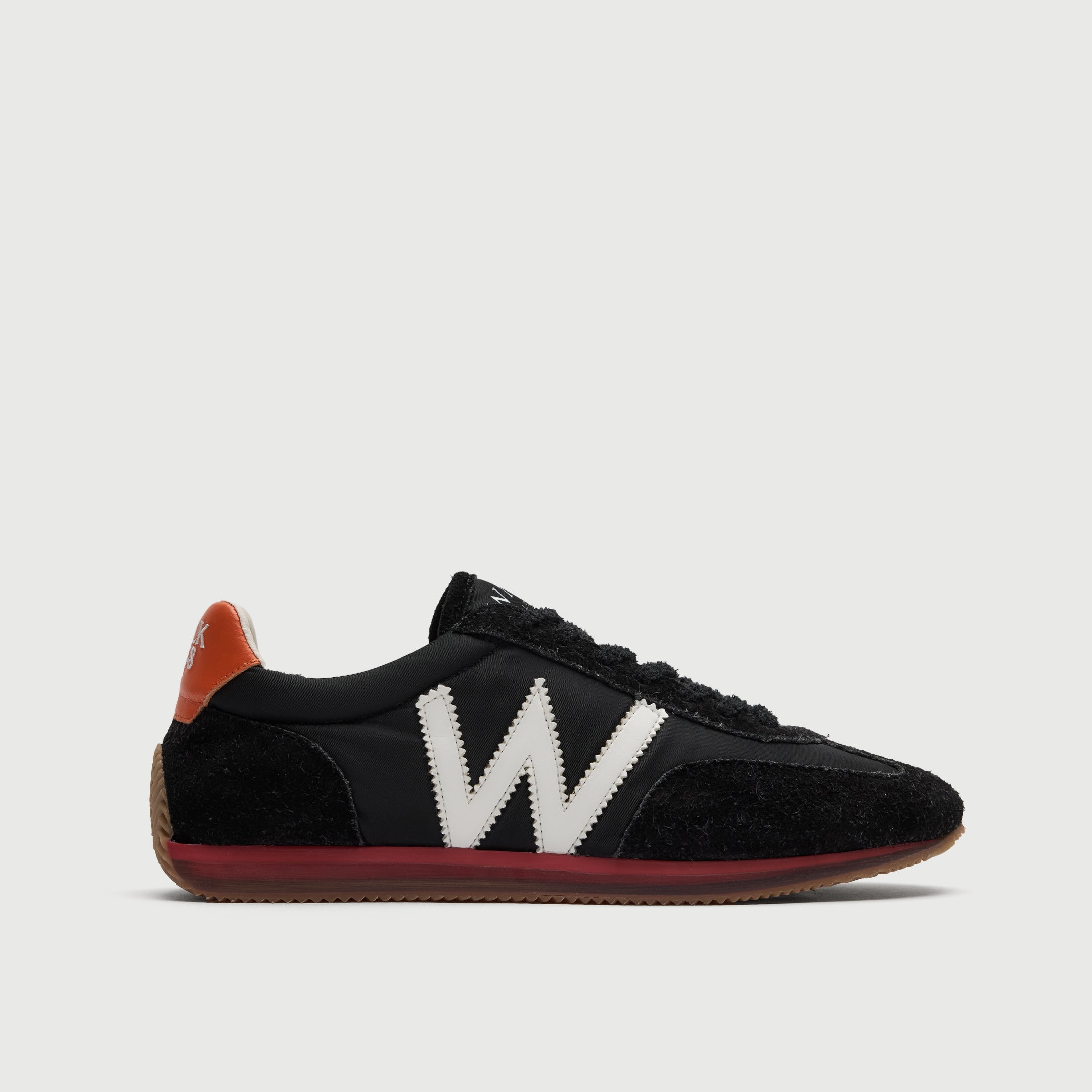 Walk London Retro Runner Trainer in Black Brushed Suede and Textile side view showing white 'w' detail, red and translucent midsole, tan outsole, and orange heel counter