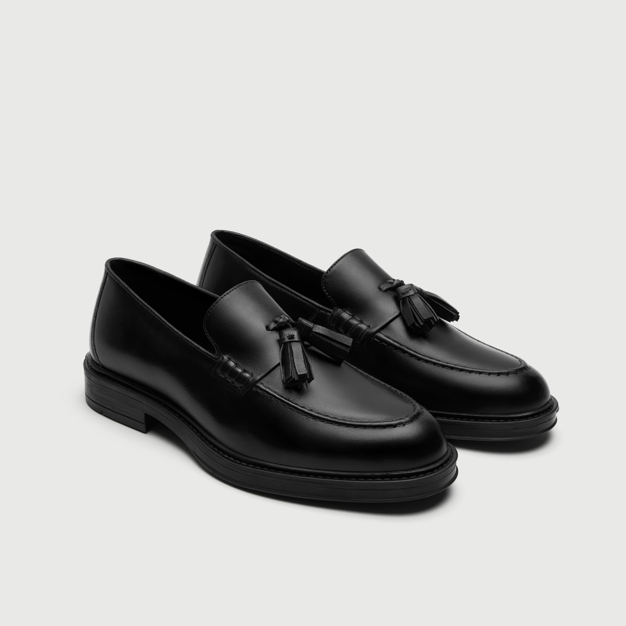 Walk London Richmond Tassel Loafers in Black Leather three quarter view showing double tassels and beefroll stitching