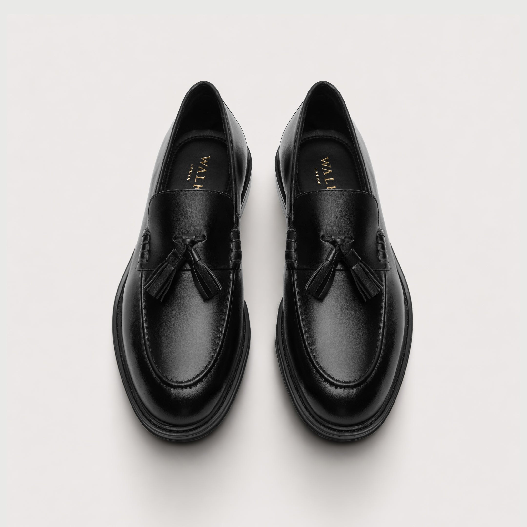 Walk London Richmond Tassel Loafers in Black Leather top view showing rounded toe shape and gold foil branding on black insoles