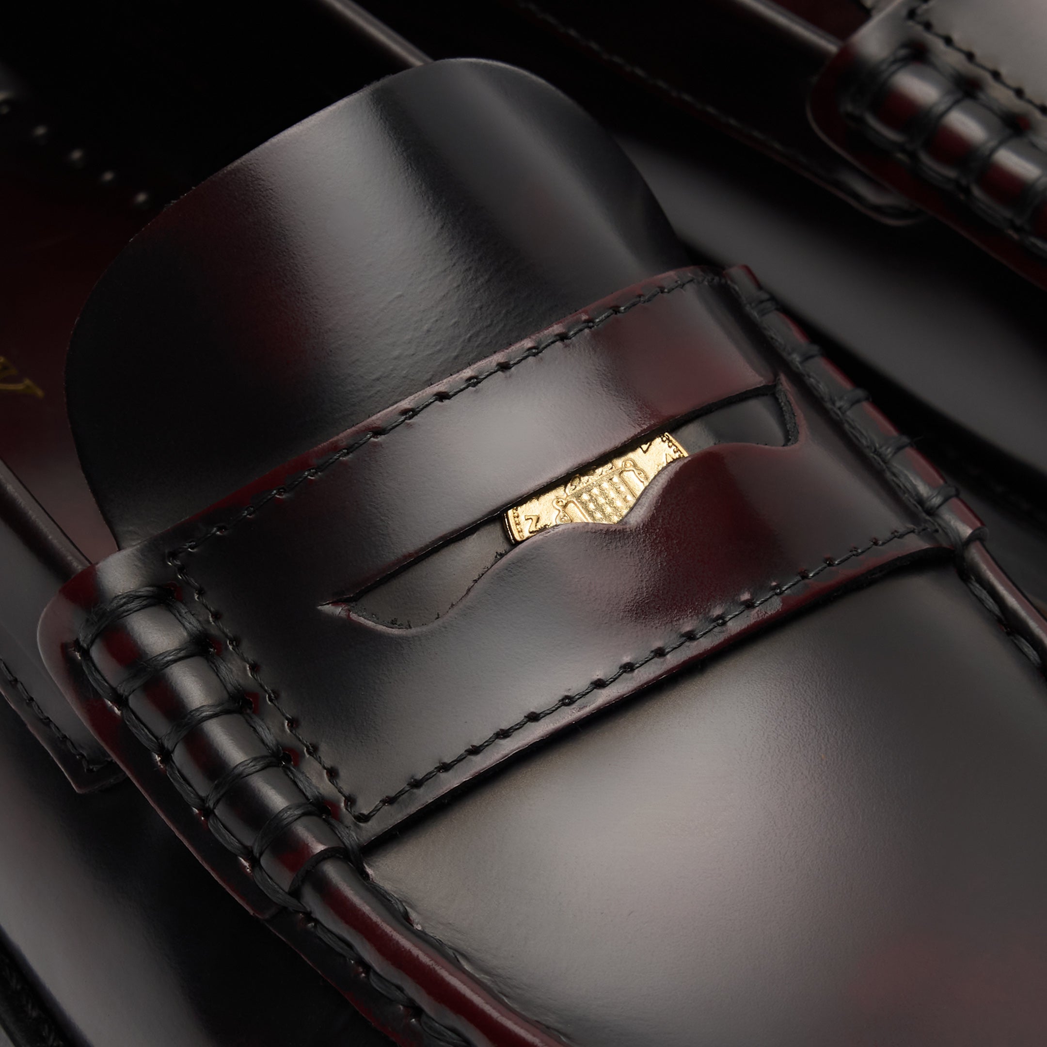 Walk London Shoreditch Penny Loafer in Burgundy Leather close up of gold penny tucked into the saddle strap and beefoll stitching